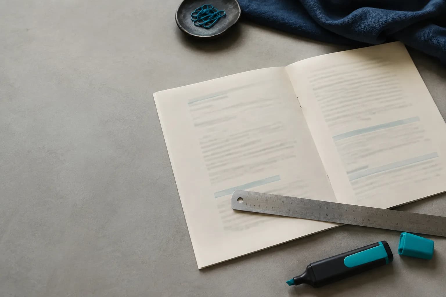 A printed rulebook open on a desk with a ruler across the page