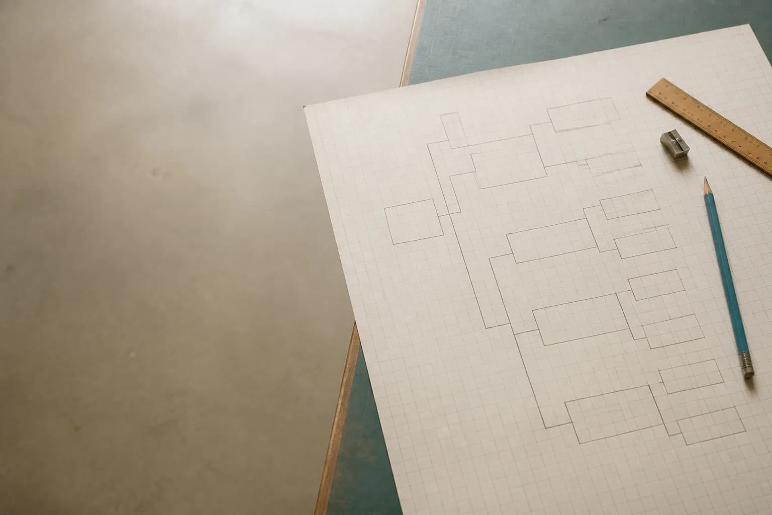 A hand-drawn tree diagram in pencil on graph paper, seen from above