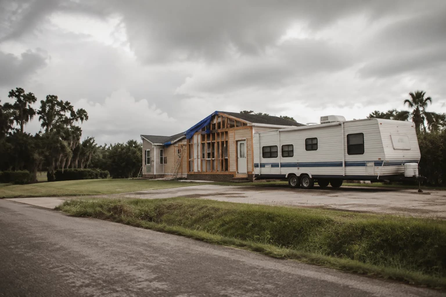 A residential driveway with a travel trailer in Louisiana terrain, no landmarks